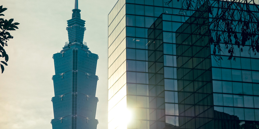 Glass vs Glass. Taiwan´s democratic symbol, Taipei 101, reflected alongside a corporate mirror of silence. A poetic contrast of transparency vs. opacity — just as this story demands. © One Man Wolf Pack